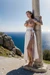 Woman in Grecian dress, tied up to pole,  big