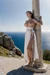 Woman in Grecian dress, tied up to pole,  big