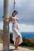 Woman in Grecian dress, tied up to pole,  big