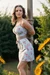 Beautiful girl in sundress tied up to a pole