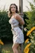 Beautiful girl in sundress tied up to a pole