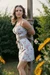Beautiful girl in sundress tied up to a pole