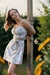 Beautiful girl in sundress tied up to a pole