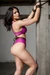 AI generated woman struggling tied up to a pole