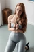 Girl in leggings tied up with hands in front struggling